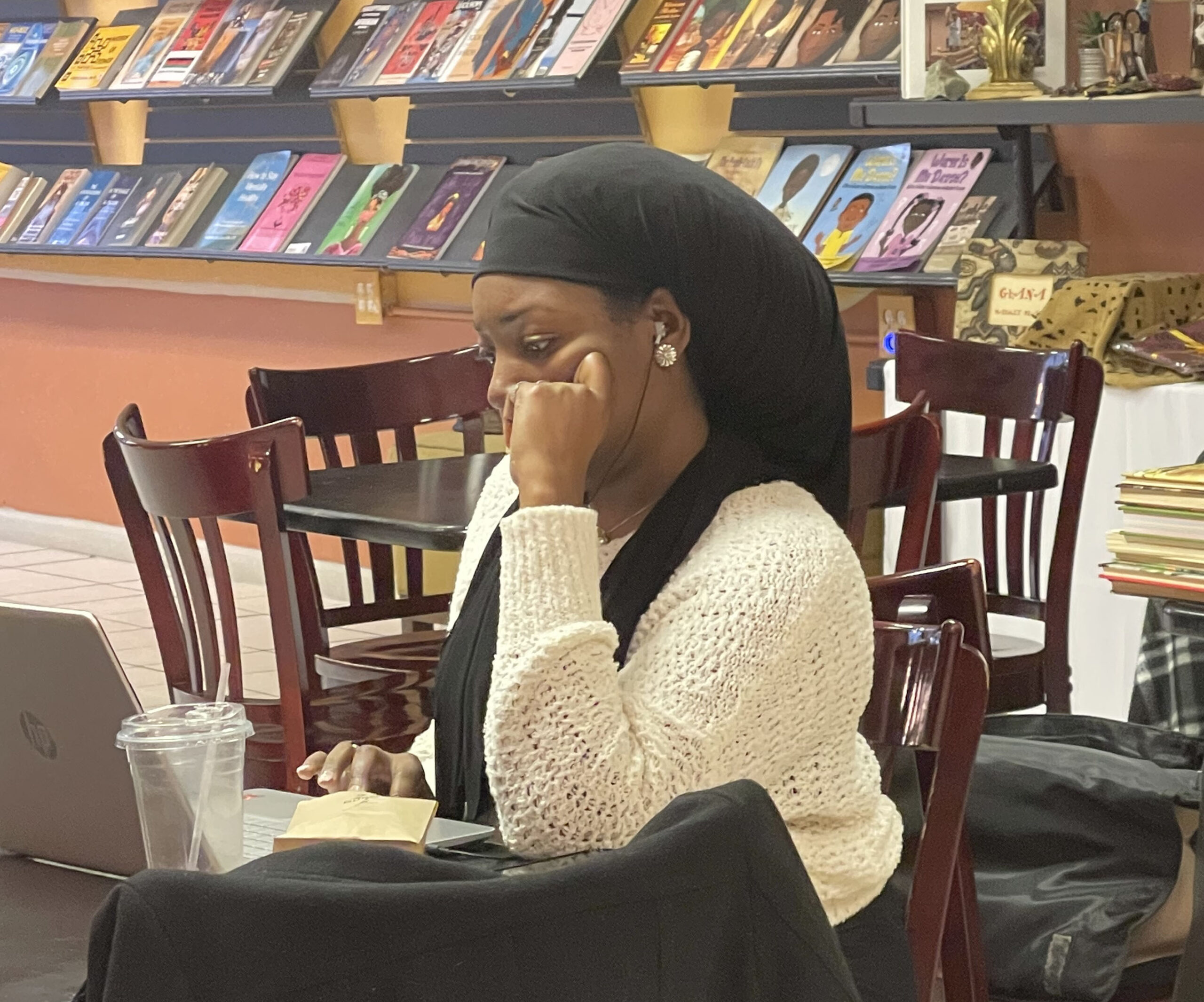 A customer working inside Akoma Coffee & Books