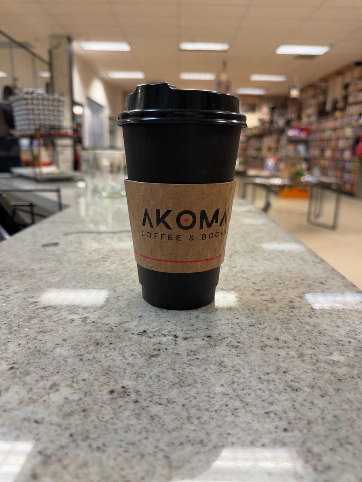 Akoma Coffee and Books branded coffee cup inside the bookstore