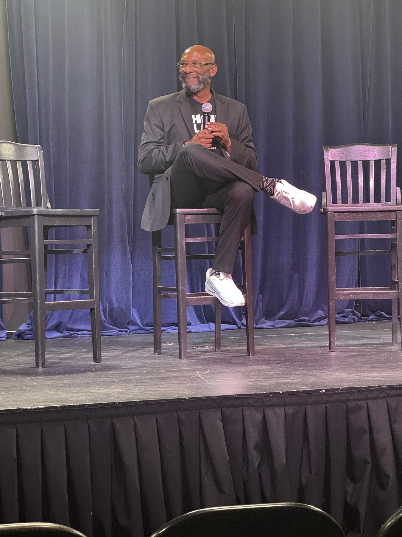 Kazemde Ajamu moderating a public panel discussion during the 2024 presidential election.