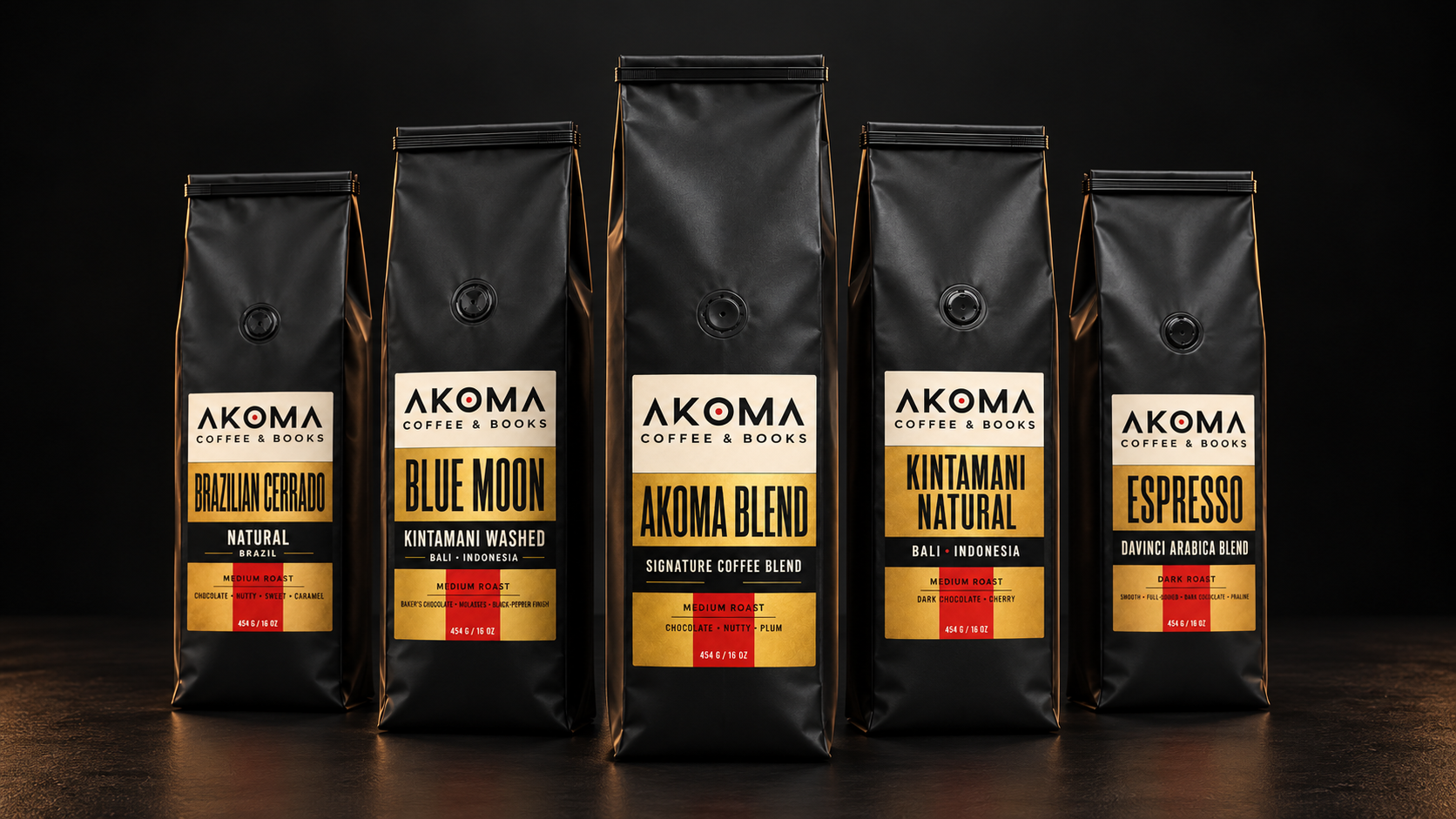 Five matte-black Akoma coffee bags, with Akoma Signature Blend centered